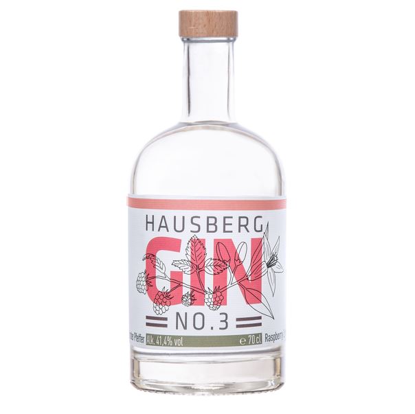Eine große Flasche Hausberg Gin No.3 mit rot-braunem Etikett und Holzgriff-Schraubverschluss auf transparentem Hintergrund.
Auf dem Etikett ist in großer Schrift der Markenname dargestellt. Im Markenschriftzug sind Grafiken der verwendeten Botanicals abgebildet.
Der Alkoholgehalt ist unten im Etikett mit 41,4 Volumenprozenten abgebildet. Daneben die Füllmenge mit 70 cl.